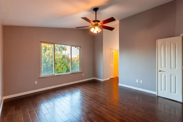 a view of an empty room with wooden floor