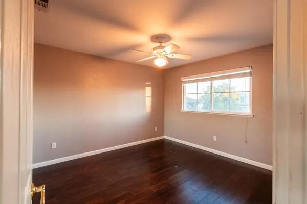 a view of a room with wooden floor