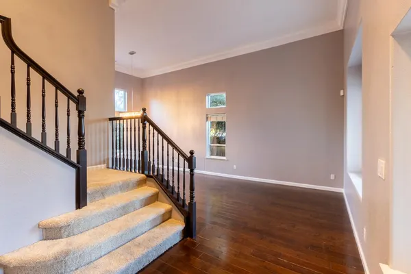 a view of entryway and hall with wooden floor