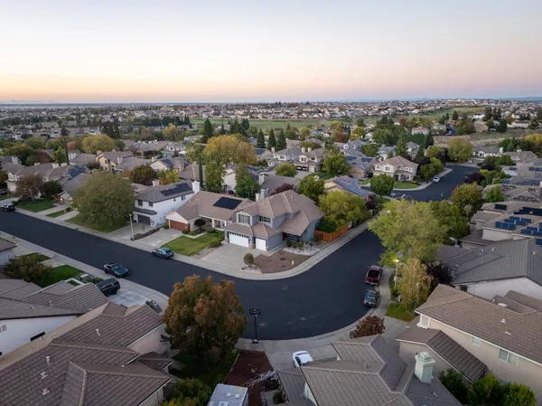 an aerial view of a house with a swimming pool