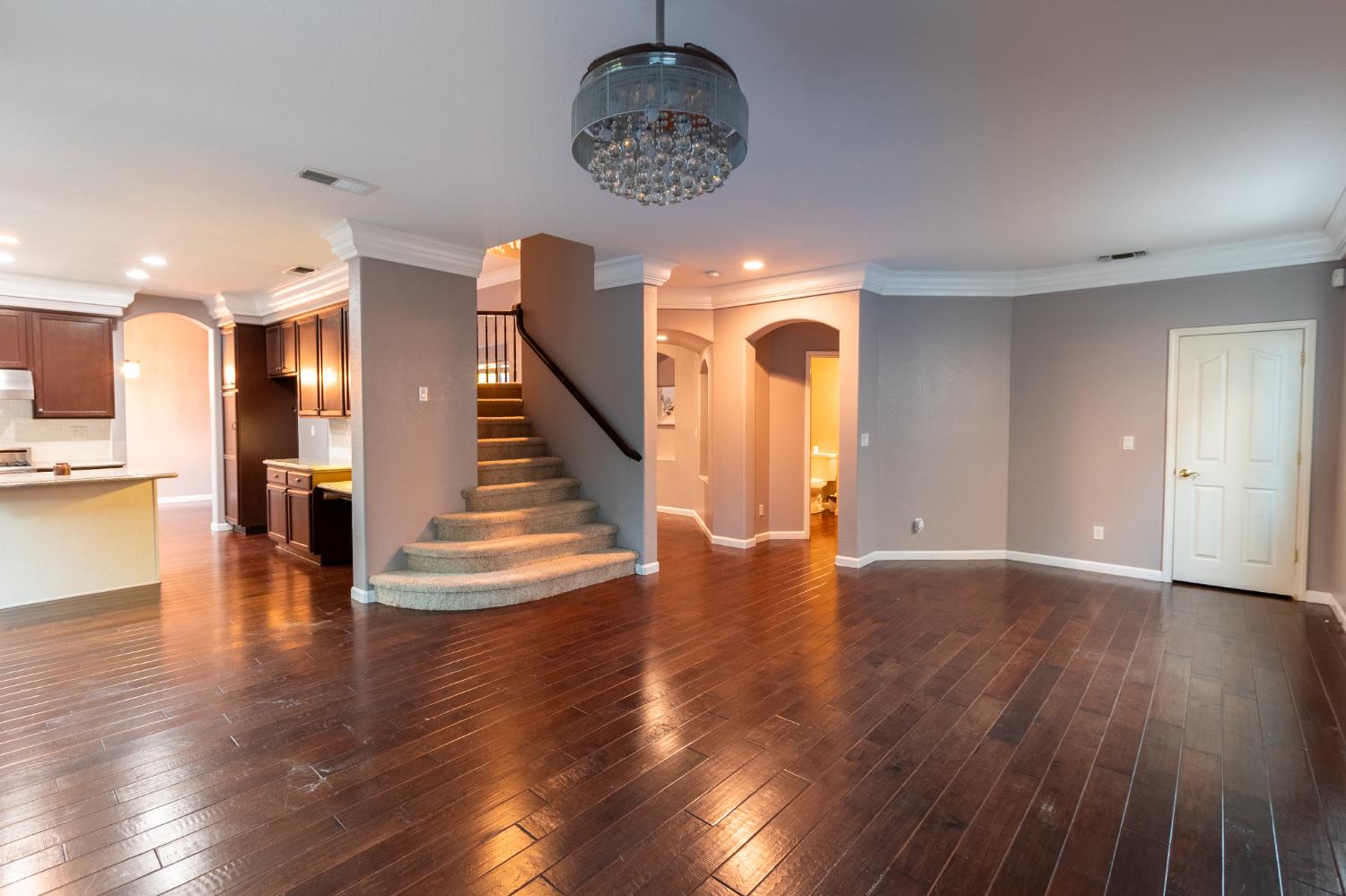2024 Archer Circle Rocklin, CA 95765 - Photo 6 of 52 a view of a room with wooden floor staircase and a kitchen