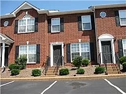 a front view of a brick house with a yard