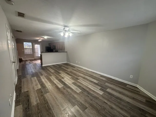 wooden floor in an empty room with a window