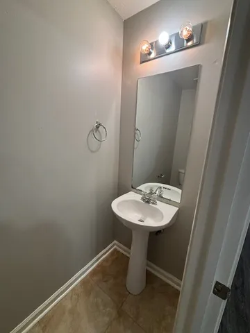 a bathroom with a sink toilet and mirror