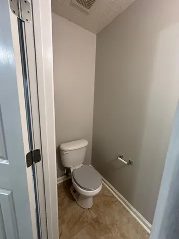 a white toilet sitting next to a sink