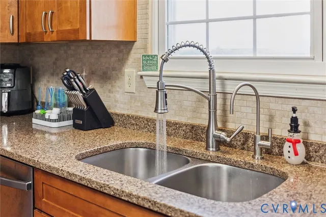 a kitchen with stainless steel appliances kitchen island granite countertop a sink and cabinets