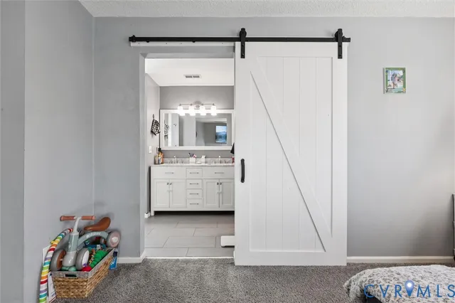 a spacious bathroom with a double vanity sink mirror and bathtub