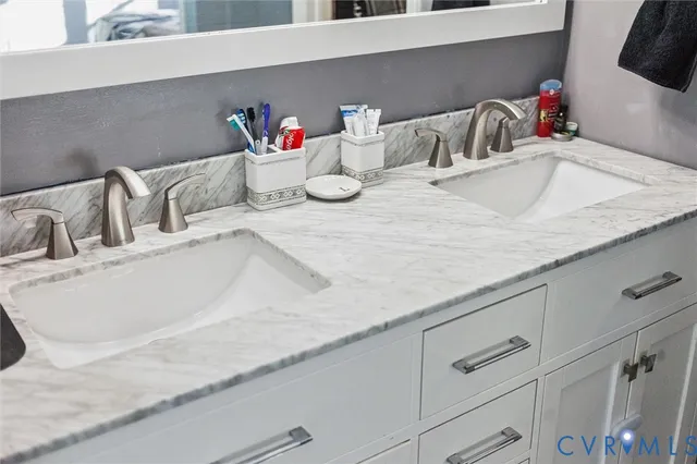 a bathroom with a double vanity sink and a mirror