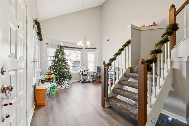 a view of a hallway with wooden floor and a potted plant