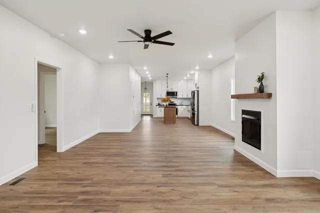 a living room with a fireplace and wooden floor