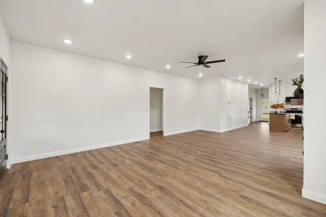 a living room with a fireplace and wooden floor