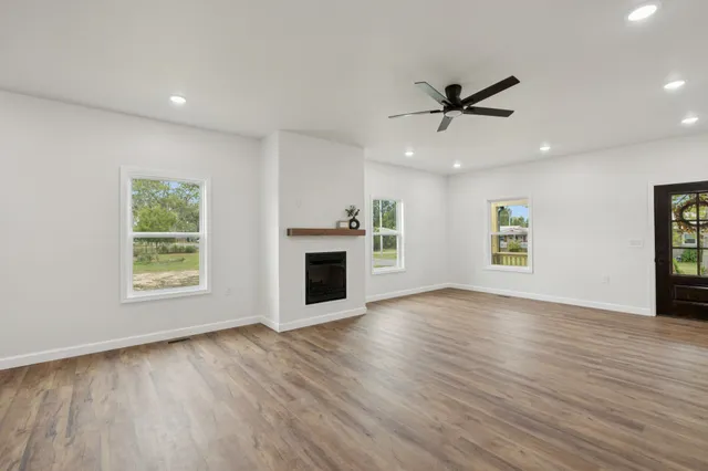 a kitchen with kitchen island granite countertop a sink a center island stainless steel appliances and cabinets