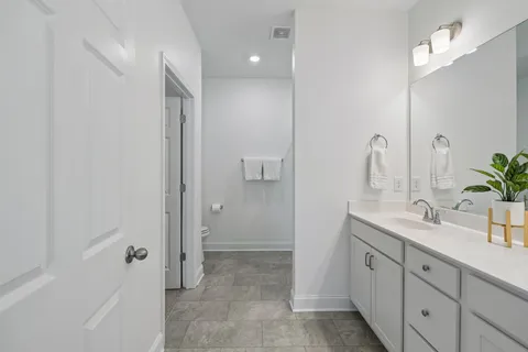 a bathroom with a double vanity sink and mirror