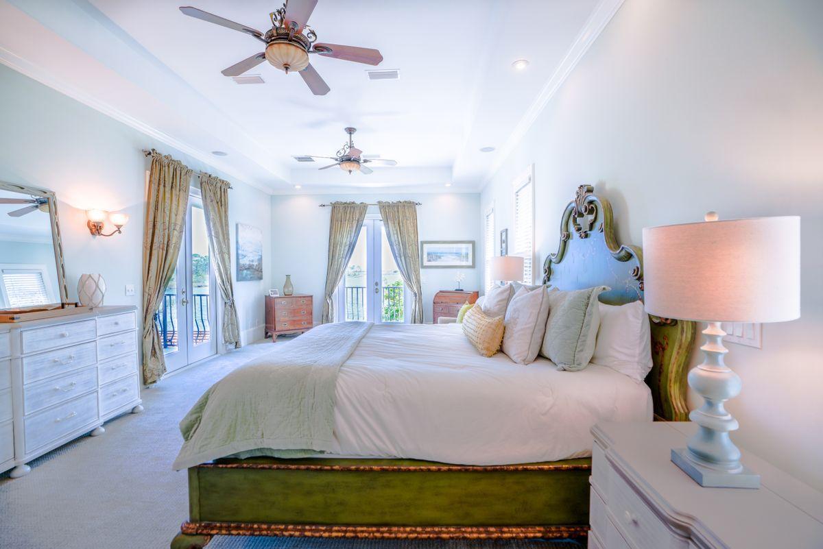 227 Wilderness Way Santa Rosa Beach, FL 32459 - Photo 23 of 45 a bedroom with a bed and a chandelier