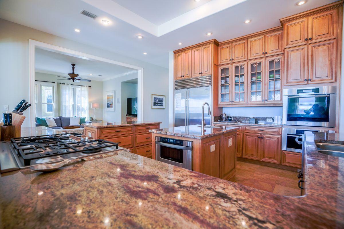 227 Wilderness Way Santa Rosa Beach, FL 32459 - Photo 8 of 45 a open kitchen with stainless steel appliances granite countertop a stove top oven a sink dishwasher and cabinets with wooden floor