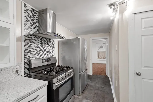 a kitchen with a stove and a refrigerator