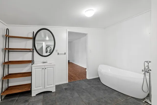 a bathroom with a bathtub and a window