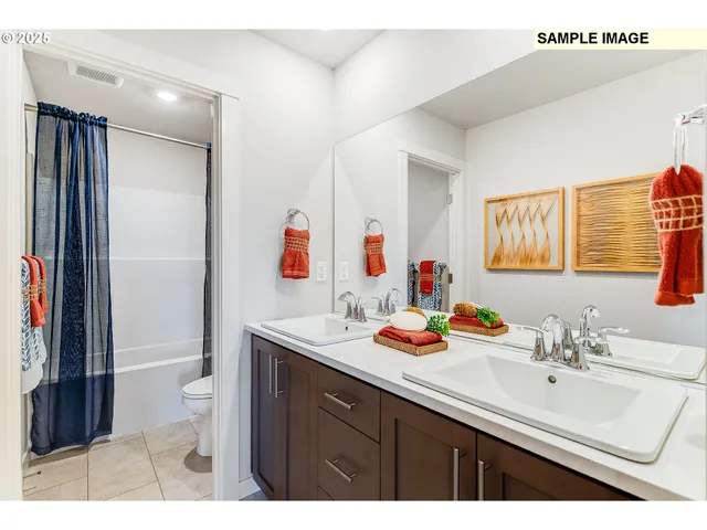 a bathroom with a sink double vanity and a toilet