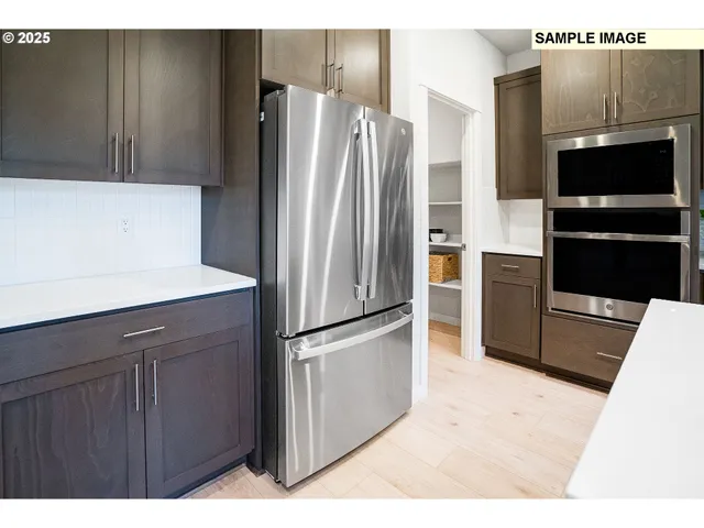a kitchen with stainless steel appliances a refrigerator and a stove