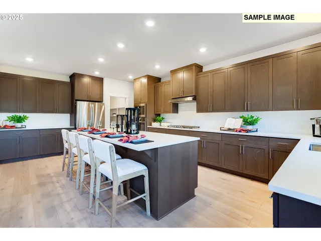 a kitchen with kitchen island granite countertop a sink and white cabinets