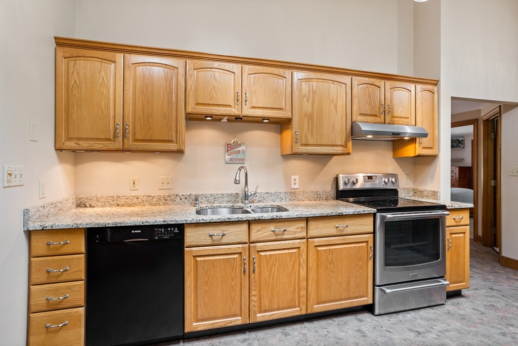 773 Great Road Stow, MA 01775 - Photo 13 of 37 a kitchen with granite countertop cabinets stainless steel appliances and a sink