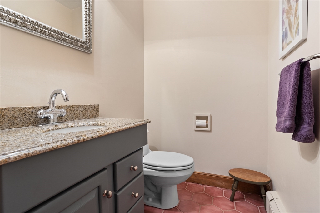 773 Great Road Stow, MA 01775 - Photo 16 of 37 a bathroom with a granite countertop sink and a toilet