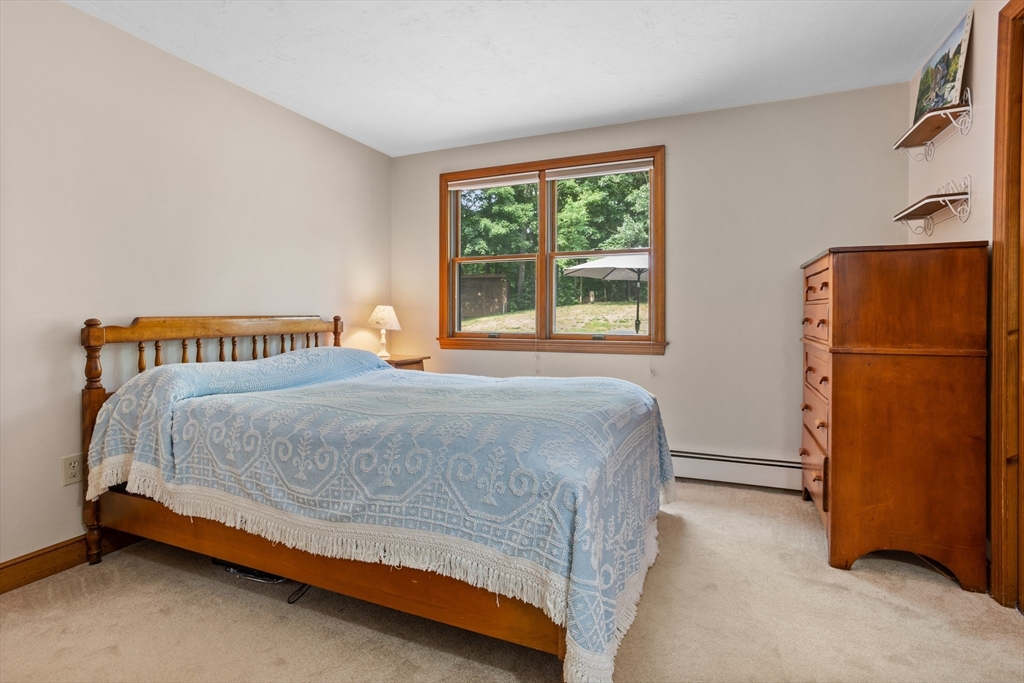 773 Great Road Stow, MA 01775 - Photo 21 of 37 a bedroom with a bed and a refrigerator