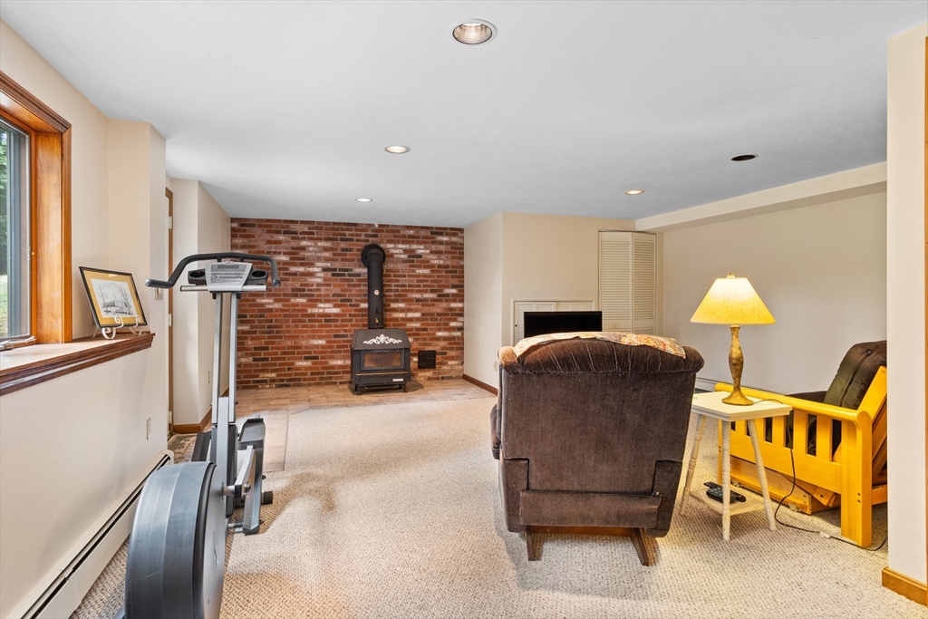 773 Great Road Stow, MA 01775 - Photo 24 of 37 a living room with furniture a flat screen tv and a large window