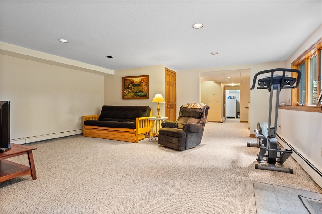 773 Great Road Stow, MA 01775 - Photo 25 of 37 a living room with furniture gym equipment and a flat screen tv