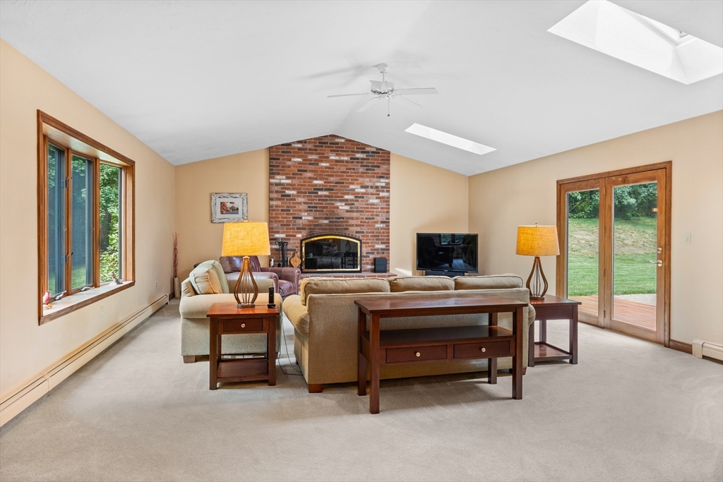 773 Great Road Stow, MA 01775 - Photo 3 of 37 a living room with furniture a flat screen tv and a fireplace