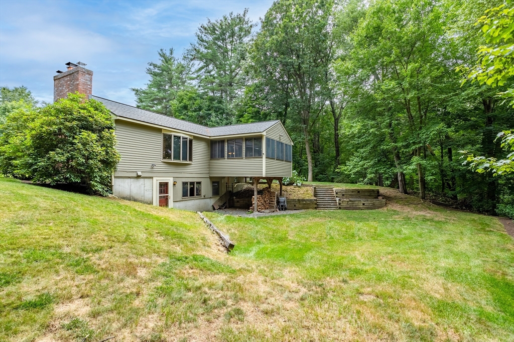 773 Great Road Stow, MA 01775 - Photo 33 of 37 a view of a house with pool and chairs