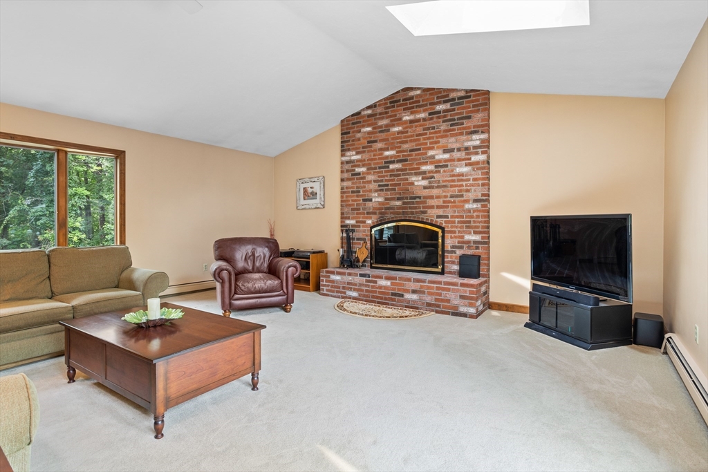 773 Great Road Stow, MA 01775 - Photo 4 of 37 a living room with furniture a flat screen tv and a fireplace