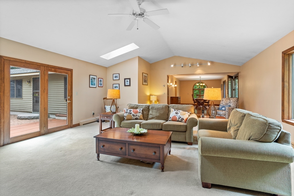 773 Great Road Stow, MA 01775 - Photo 7 of 37 a living room with furniture and a chandelier