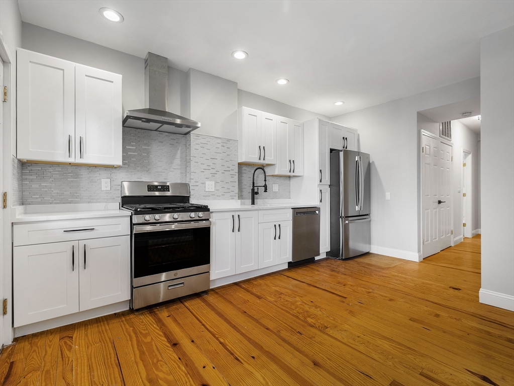 a kitchen with stainless steel appliances a refrigerator sink and cabinets