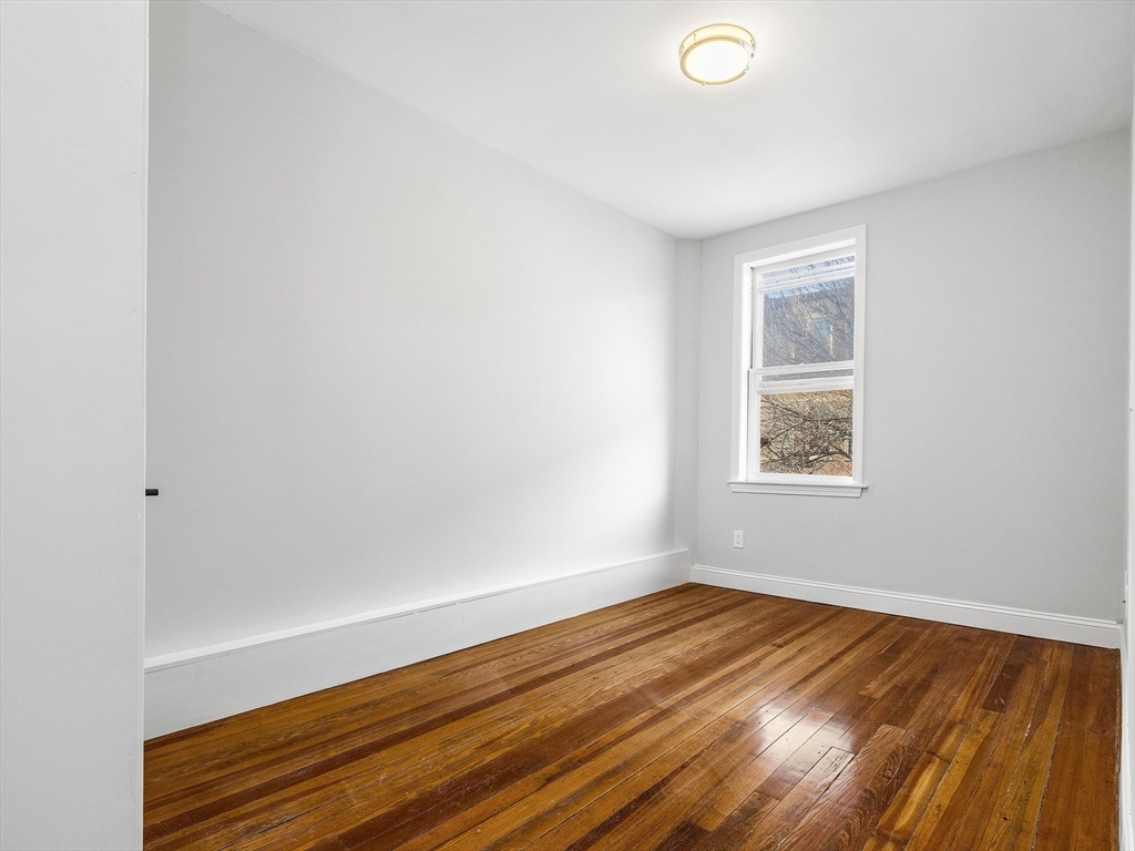 131 A Cottage Street, Unit 2A Boston, MA 02128 - Photo 12 of 16 a view of a room with wooden floor and window