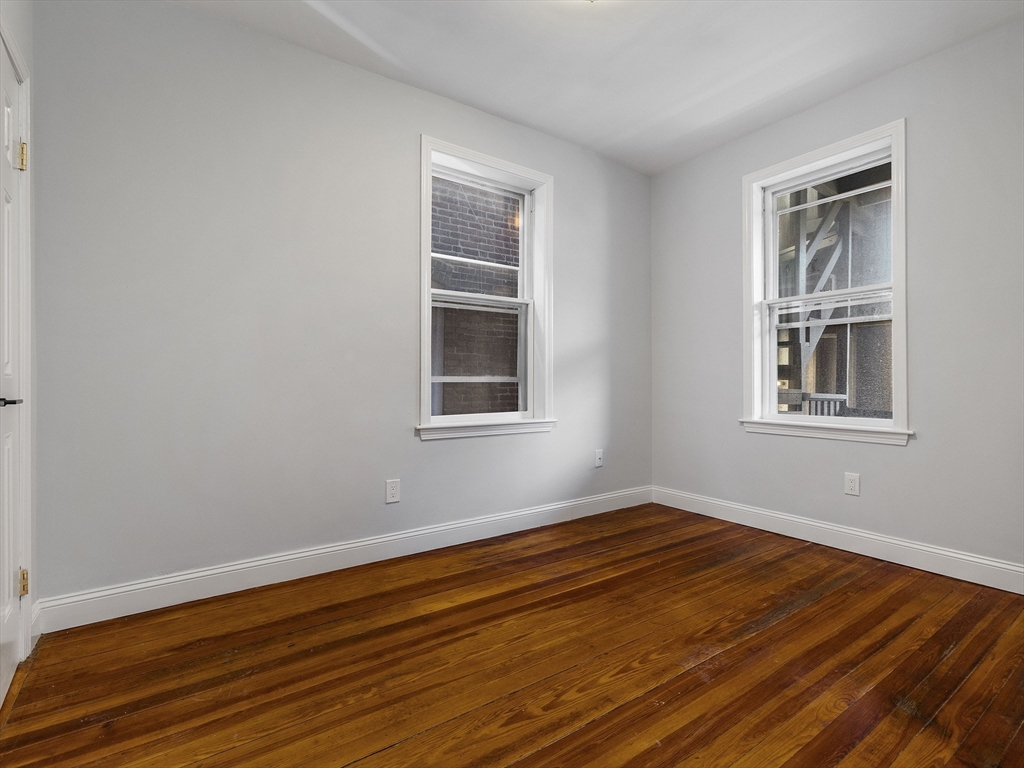 131 A Cottage Street, Unit 2A Boston, MA 02128 - Photo 6 of 16 a view of empty room with wooden floor and fan