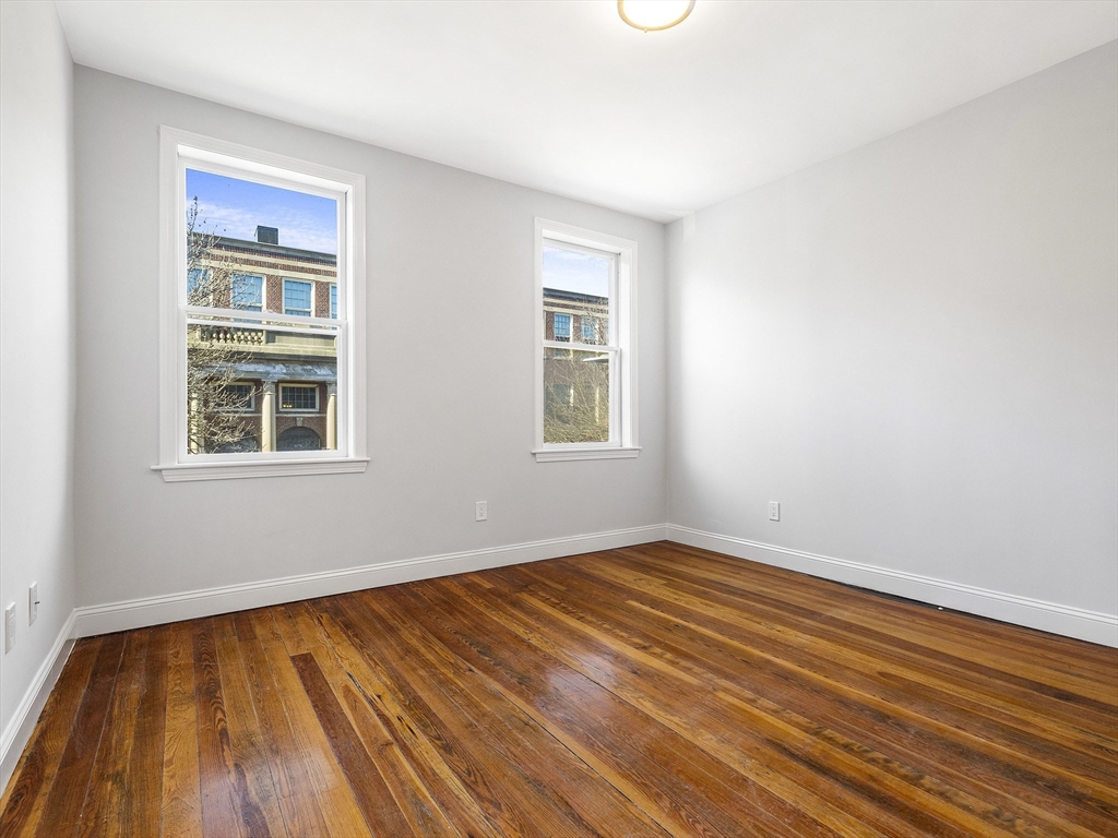 131 A Cottage Street, Unit 2A Boston, MA 02128 - Photo 10 of 16 a view of empty room with wooden floor and fan