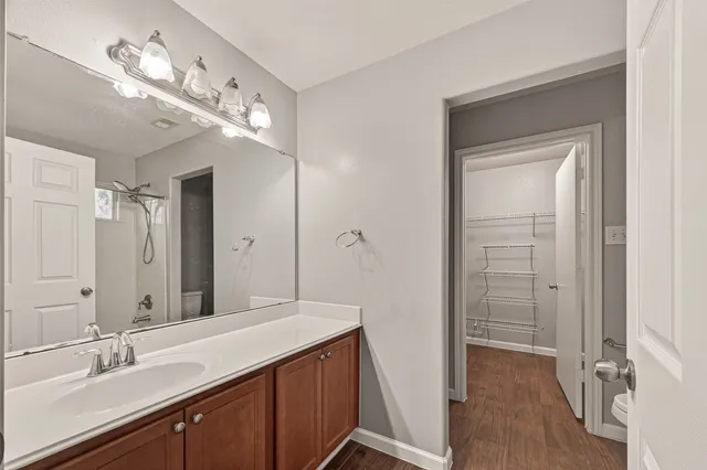 a spacious bathroom with a double vanity sink mirror and shower