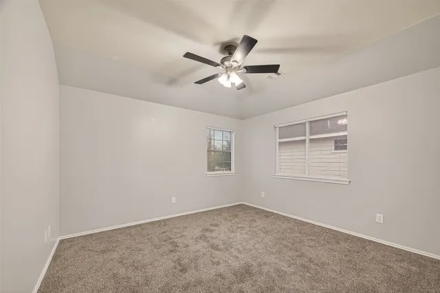 a view of a livingroom with a ceiling fan and a window