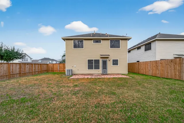 a view of a backyard with potted plants and wooden fence