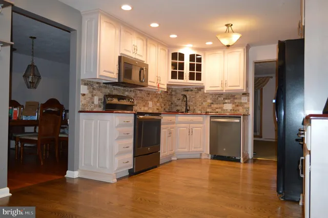 a kitchen with stainless steel appliances granite countertop a stove and a refrigerator