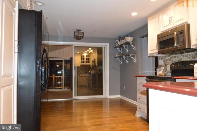 a view of a kitchen with a sink and a fireplace