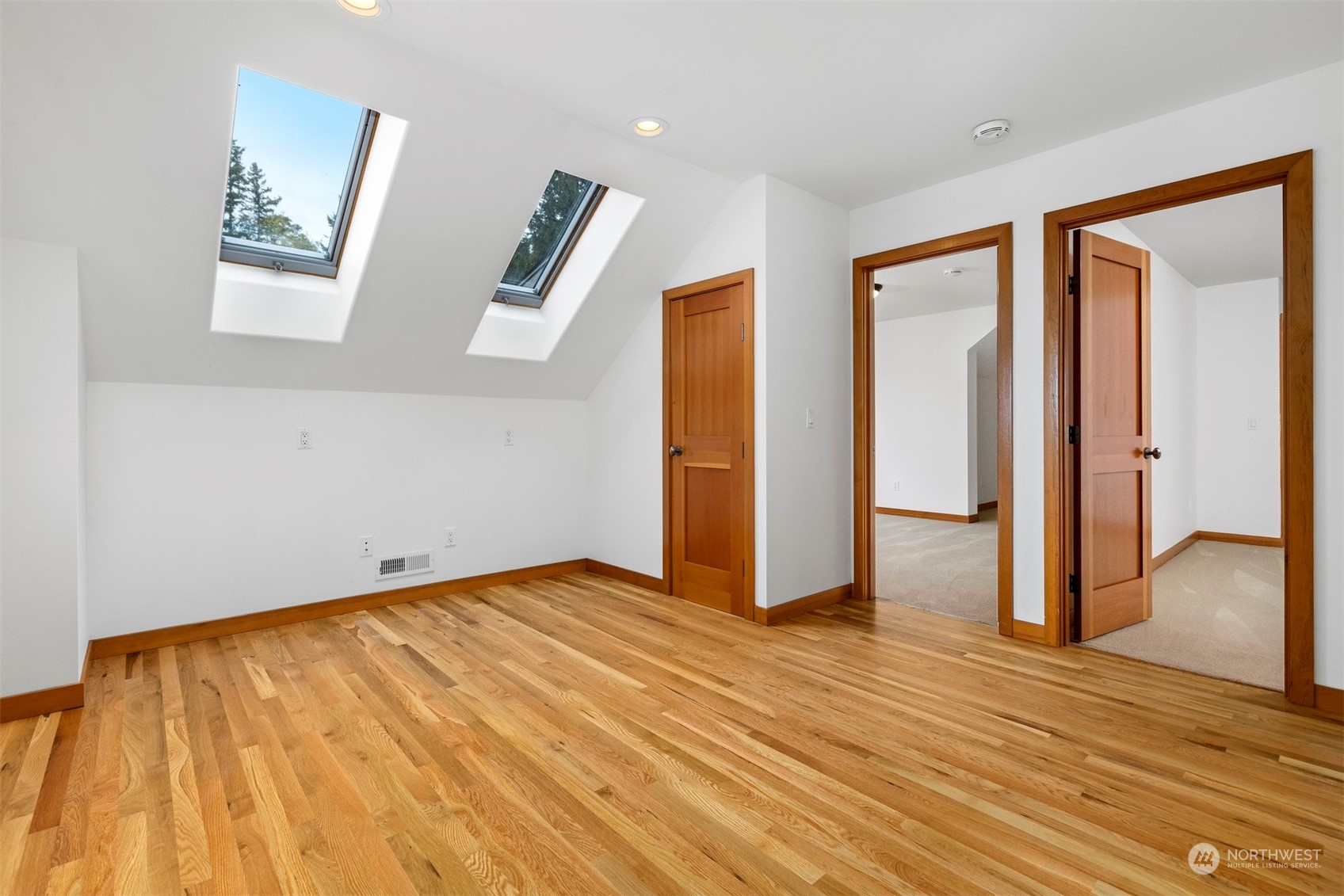 804 Fieldston Road Bellingham, WA 98225 - Photo 24 of 40 a view of an empty room with wooden floor and a bathroom