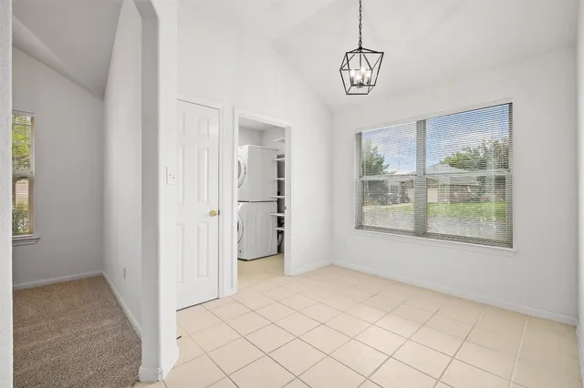 a view of empty room with window and front door