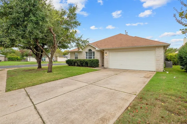 a front view of house with yard and green space