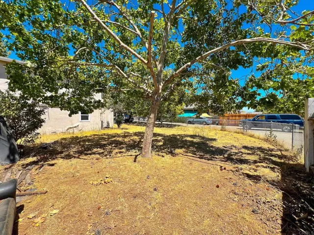 a view of a house with backyard and swimming pool
