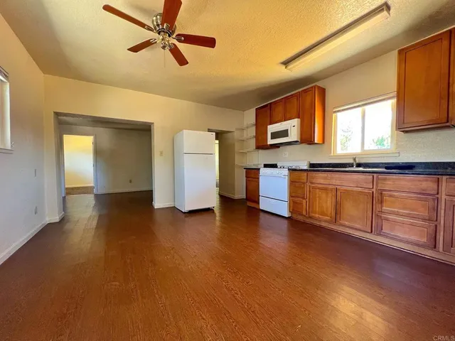 a view of a kitchen cabinets and wooden floor