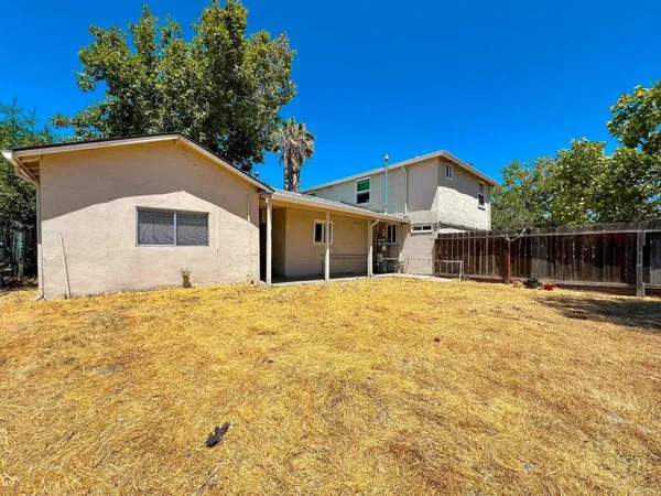 a house view with swimming pool in front of it