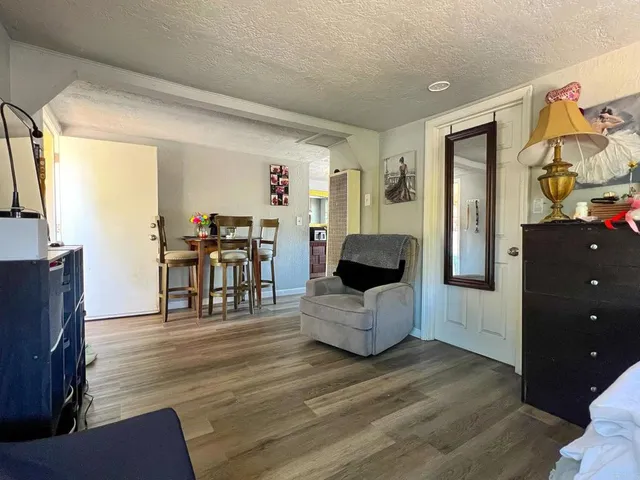 a living room with furniture and wooden floor