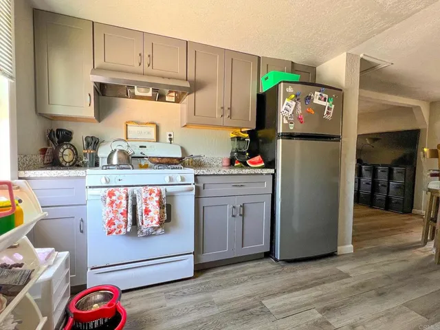 a playing room with furniture and a wooden floor